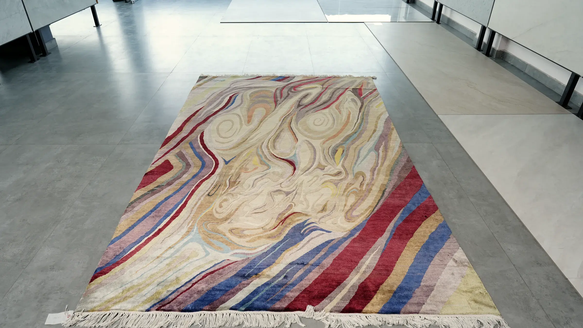 A gold and rose silk rug in a hallway