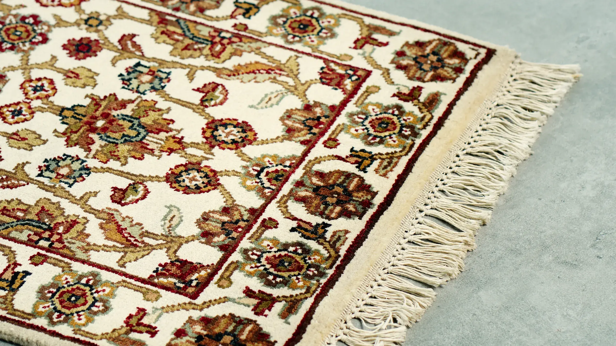 Ivory floral rug with a burgundy border, hand-knotted