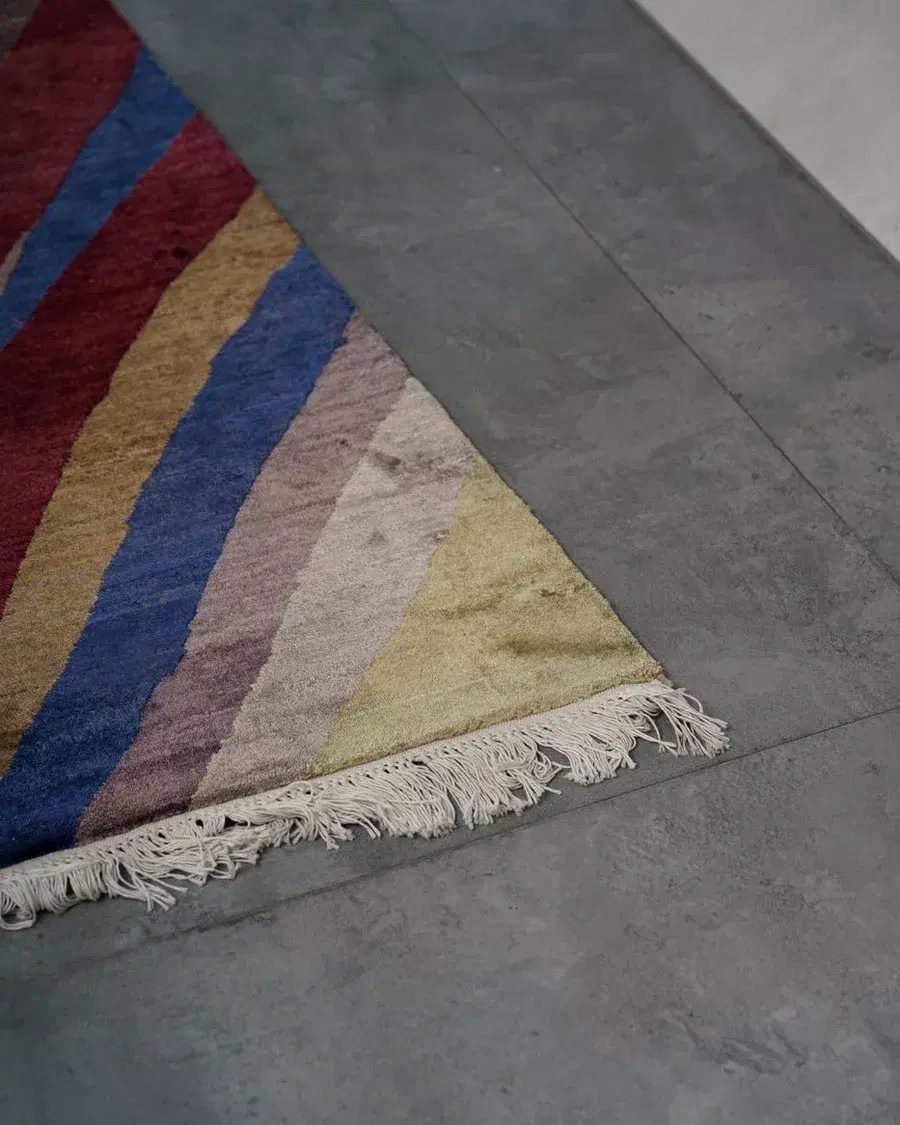 Striped rug in rose, blue and sand