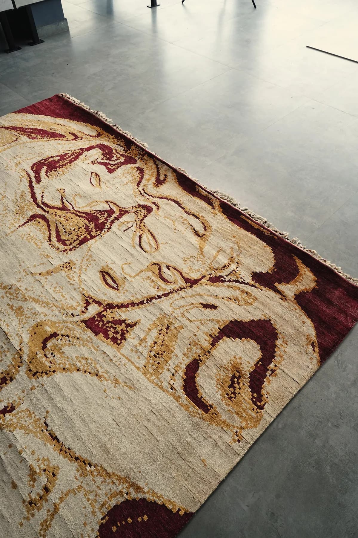 Akarsha, an ivory and burgundy Shallymar rug laid at an angle
