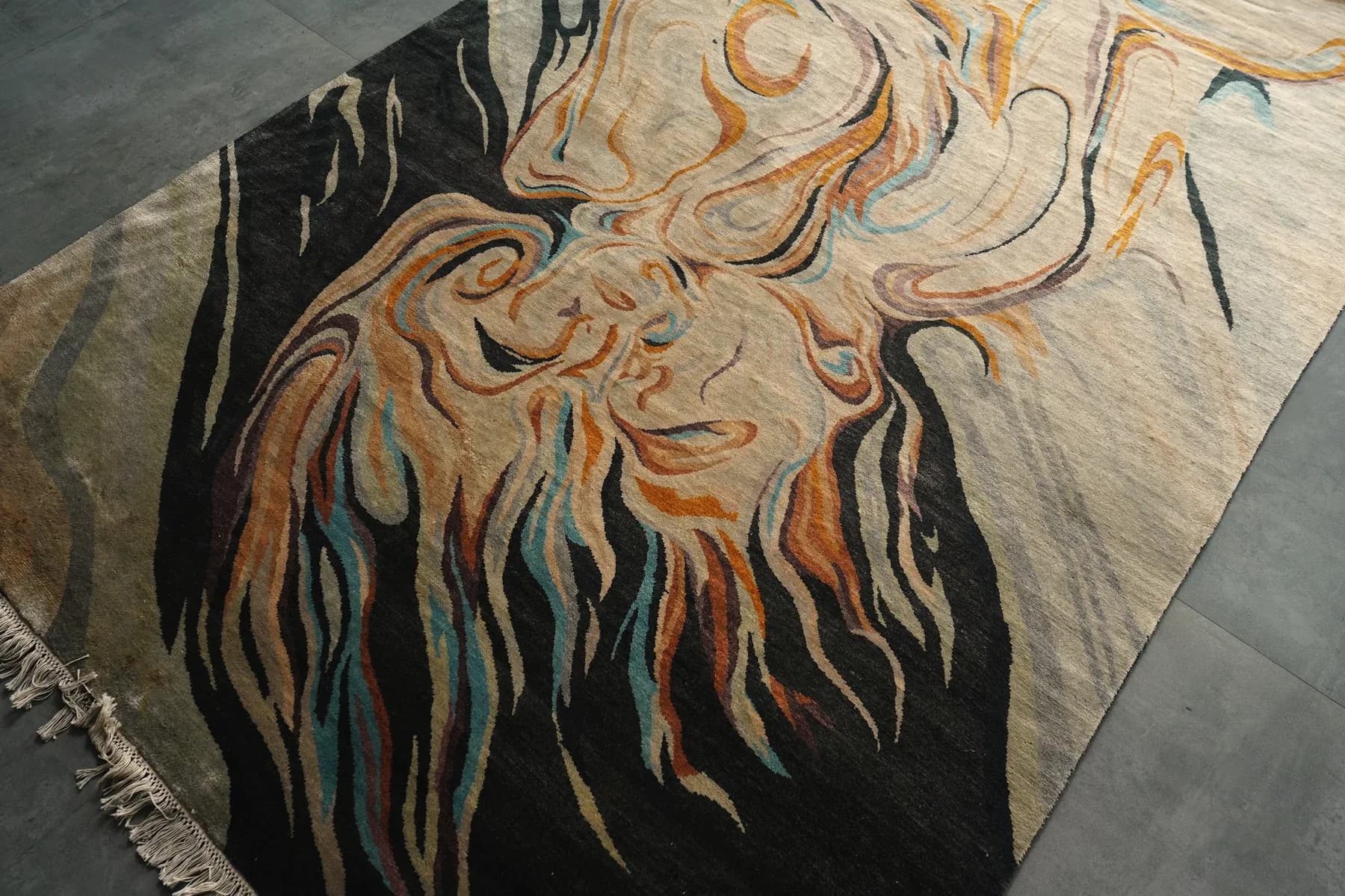 Raga, a Shallymar rug of a face in ochre and ink, seen low across the pile