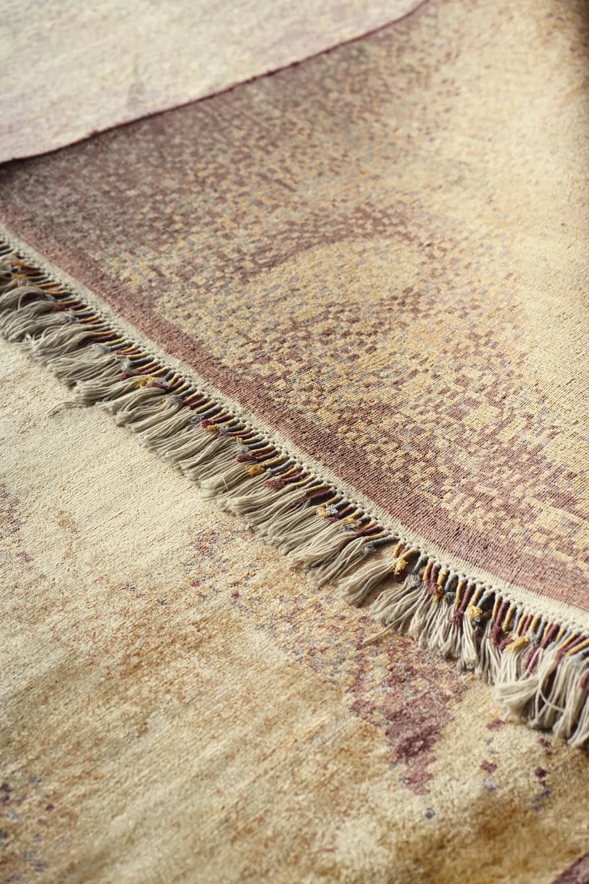 Vaitaliki, a sand and rose Shallymar rug folded back at the corner