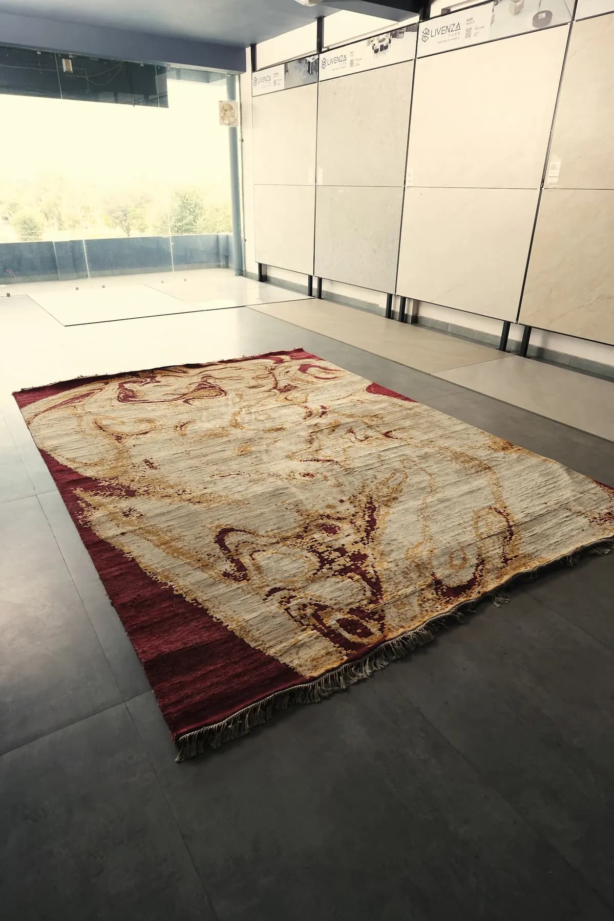 Akarsha, an ivory and burgundy Shallymar rug laid at an angle