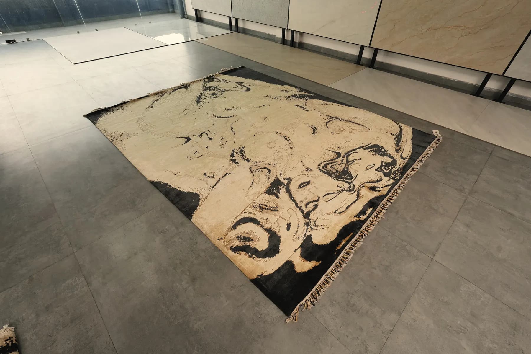 Kavya, two faces drawn in ink on an ivory Shallymar rug