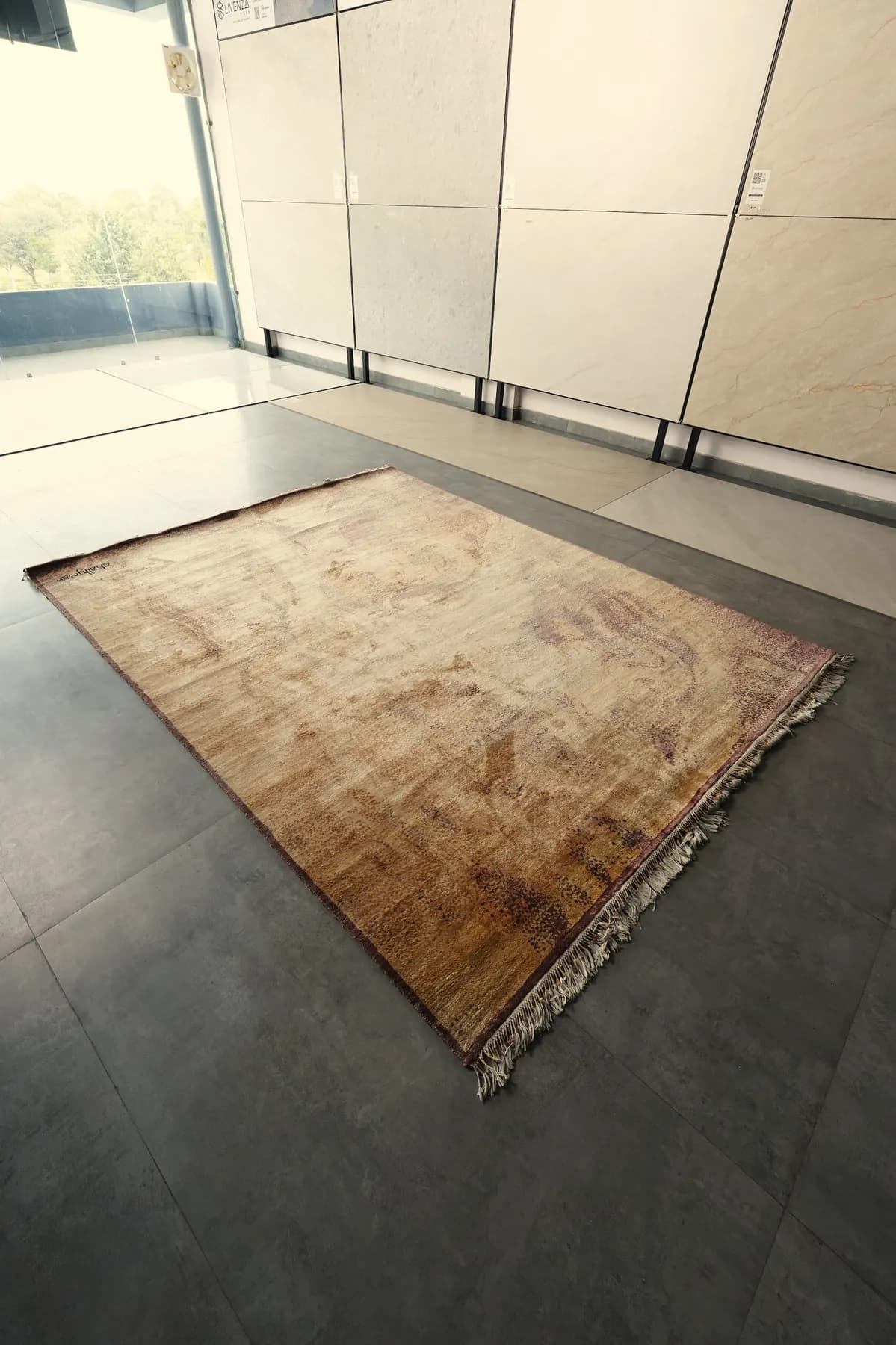 Vaitaliki, a sand and rose Shallymar rug folded back at the corner